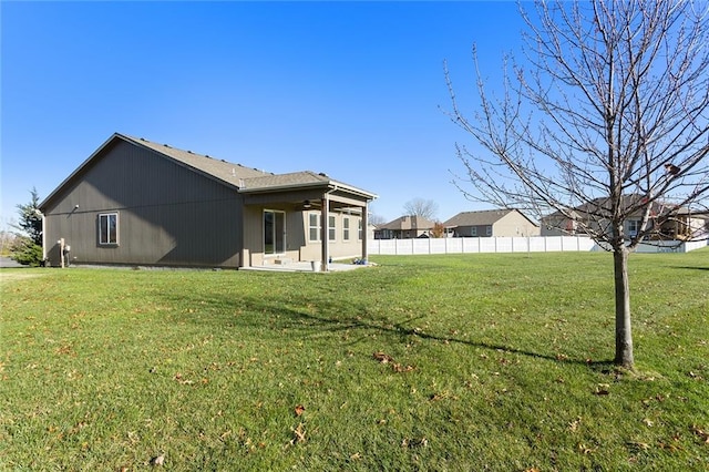 view of side of home with a yard and a patio