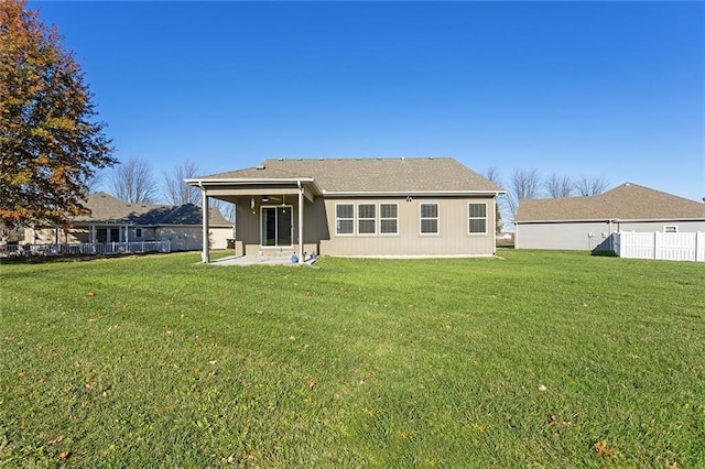 rear view of house with a lawn