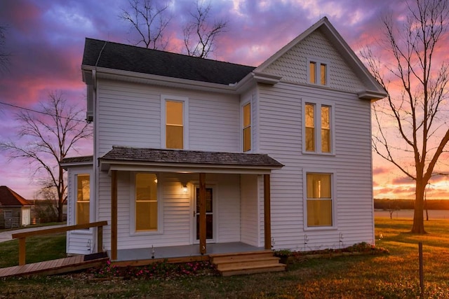 view of front of house with a yard and covered porch