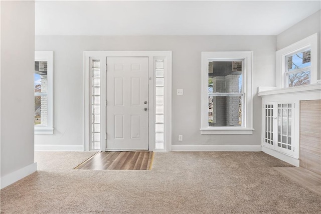 view of carpeted foyer entrance