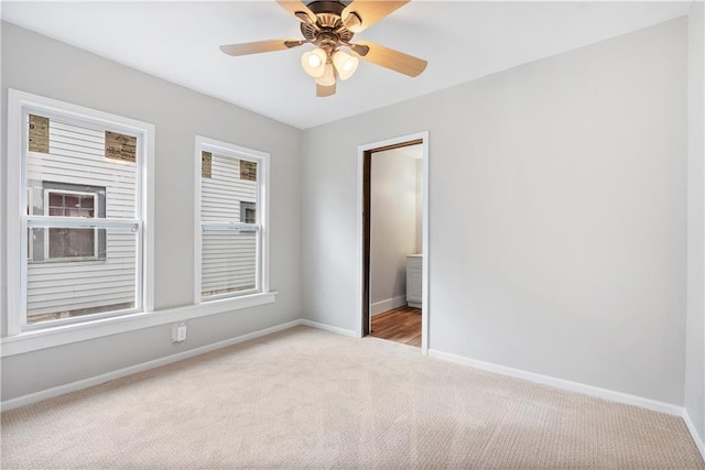 unfurnished room featuring light carpet and ceiling fan