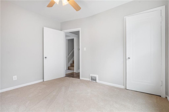 unfurnished bedroom with carpet flooring and ceiling fan