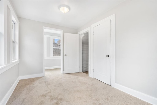 unfurnished bedroom featuring light colored carpet