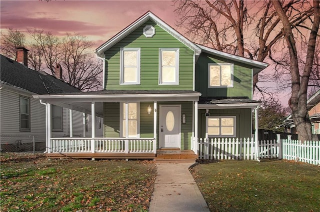 view of front of home with a yard and a porch