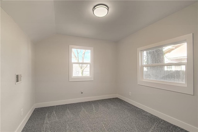 additional living space featuring carpet flooring and lofted ceiling