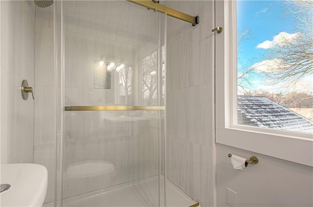 bathroom with a shower with door