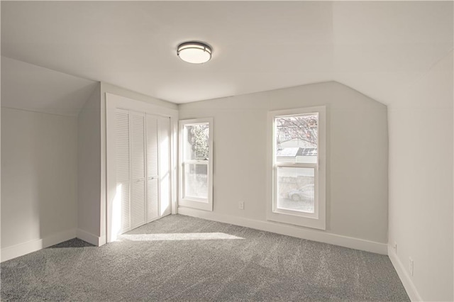 additional living space with carpet floors and vaulted ceiling