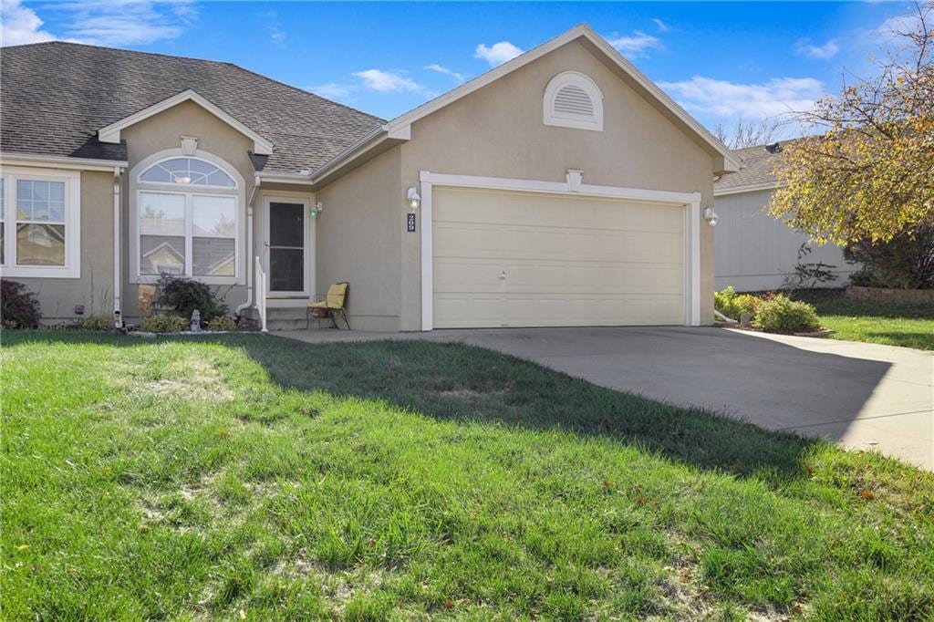 single story home with a front lawn and a garage