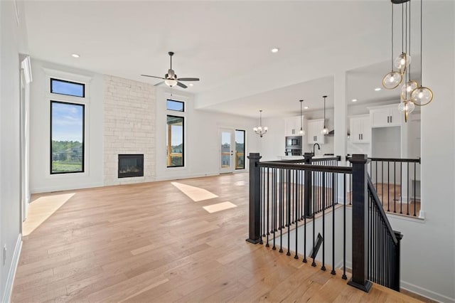 interior space featuring a fireplace, a wealth of natural light, sink, and light wood-type flooring