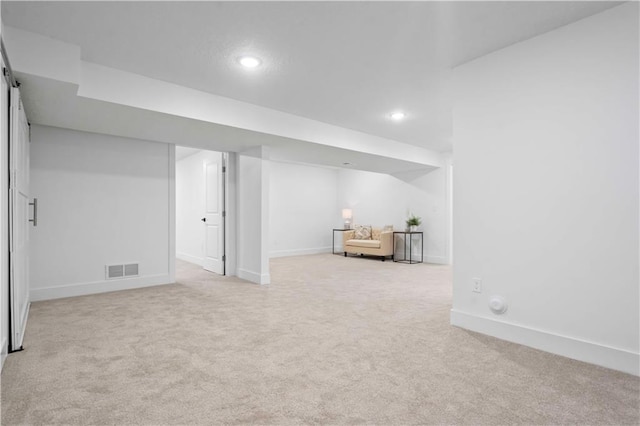 finished basement with recessed lighting, visible vents, baseboards, and light colored carpet