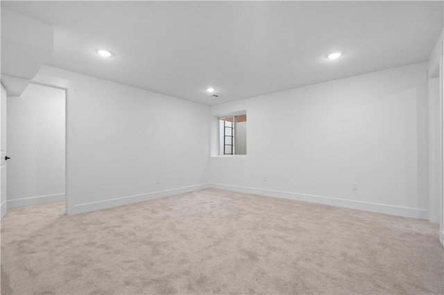 basement with recessed lighting, baseboards, and carpet flooring