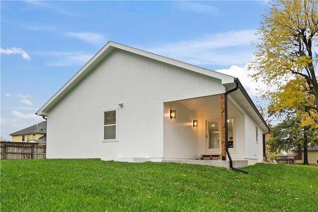 rear view of property featuring a yard