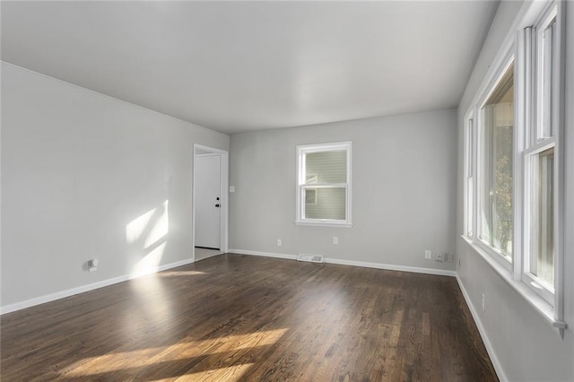 unfurnished room featuring dark hardwood / wood-style flooring