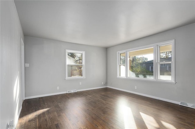 unfurnished room featuring dark hardwood / wood-style floors