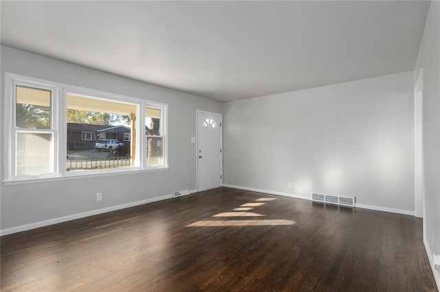 unfurnished room featuring dark hardwood / wood-style flooring