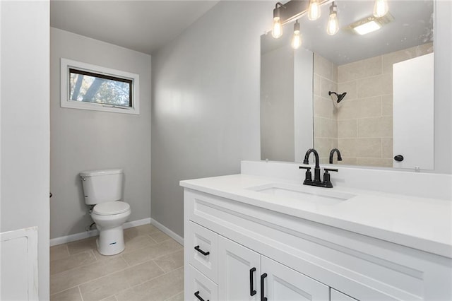 bathroom with tile patterned flooring, vanity, and toilet