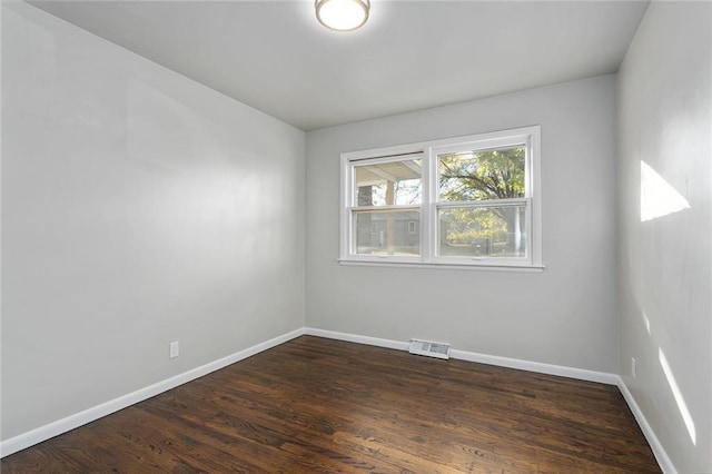 empty room with dark hardwood / wood-style floors