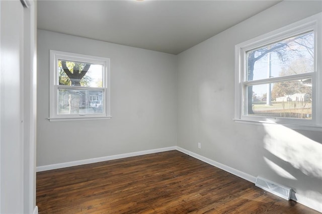 unfurnished room featuring dark wood-type flooring