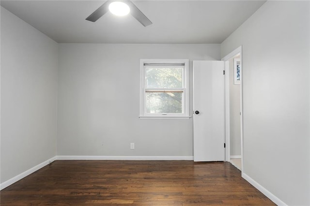 unfurnished room with ceiling fan and dark hardwood / wood-style flooring