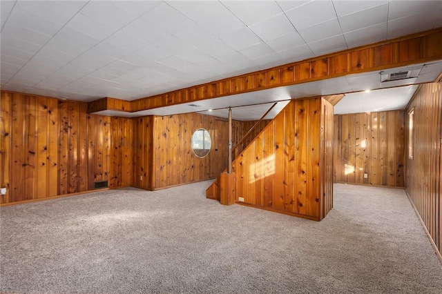 basement with carpet floors and wooden walls