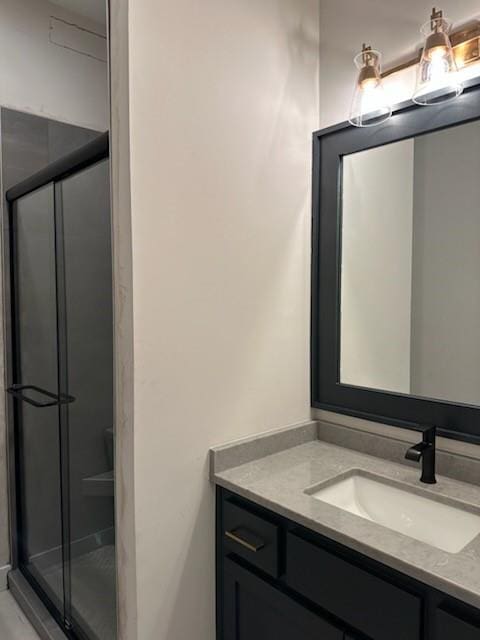 bathroom featuring vanity and an enclosed shower