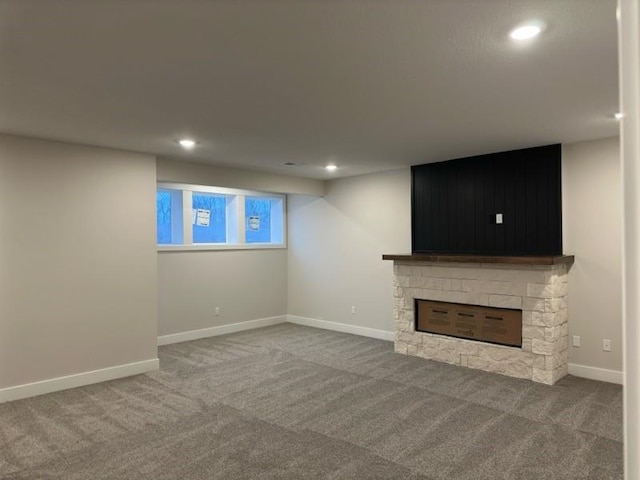 basement with carpet floors and a fireplace