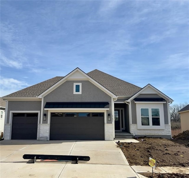 craftsman house with concrete driveway, roof with shingles, an attached garage, and stucco siding