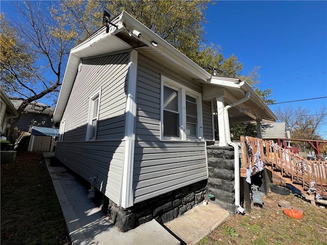 view of property exterior featuring a wooden deck