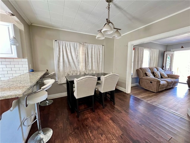 dining room featuring crown molding and dark hardwood / wood-style flooring