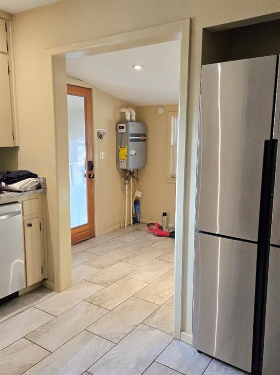 kitchen with secured water heater and appliances with stainless steel finishes