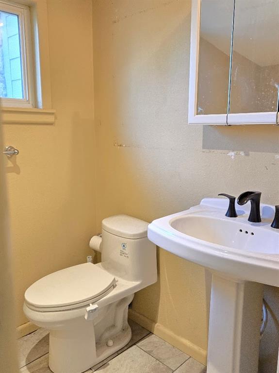 bathroom featuring tile patterned floors and toilet