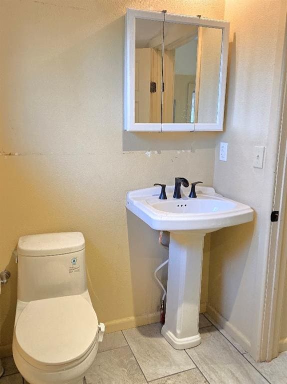 bathroom with tile patterned flooring and toilet