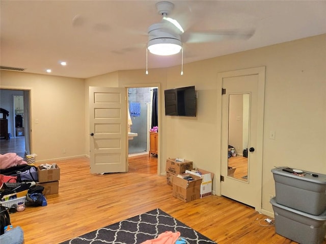 interior space featuring ceiling fan, wood-type flooring, and ensuite bathroom