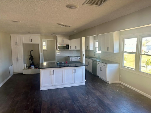 kitchen featuring white cabinets, dark hardwood / wood-style floors, sink, and stainless steel appliances