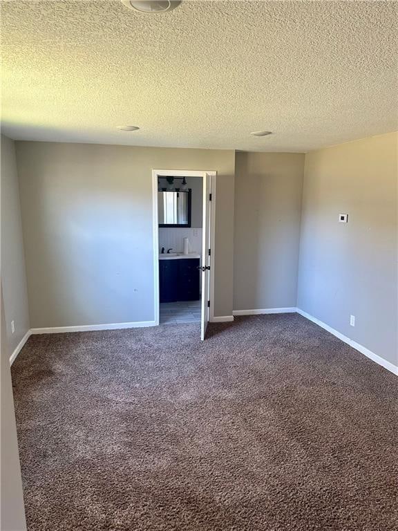 carpeted spare room with a textured ceiling