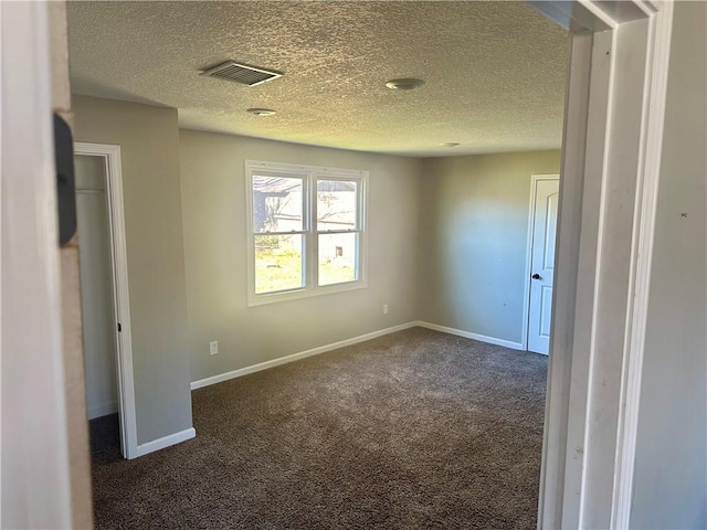 carpeted spare room featuring a textured ceiling