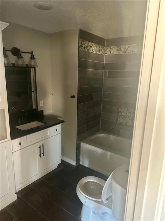 full bathroom featuring vanity, toilet, and tiled shower / bath combo