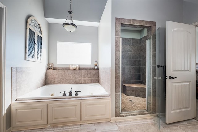 bathroom featuring tile patterned floors and separate shower and tub