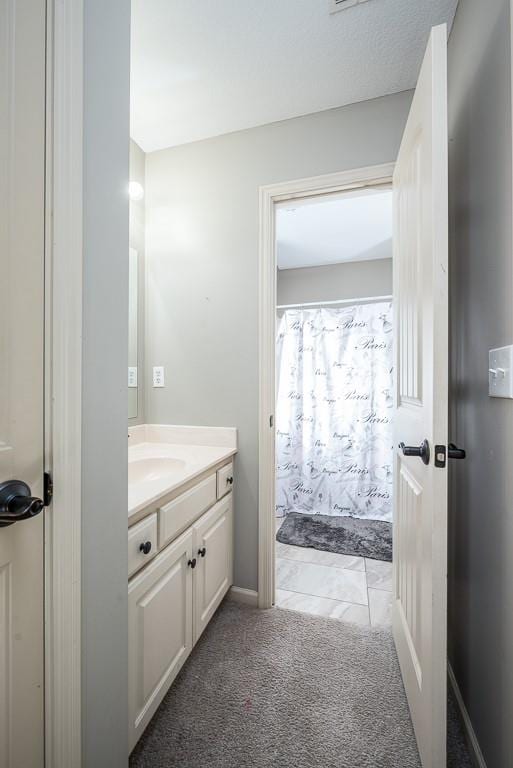 bathroom with a shower with curtain and vanity