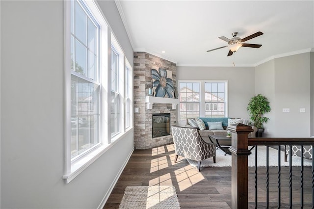 11901 S Tallgrass Dr Unit 702, Olathe, KS 66061 - living room featuring crown molding, baseboards, ceiling fan, a fireplace, and dark wood-style floors