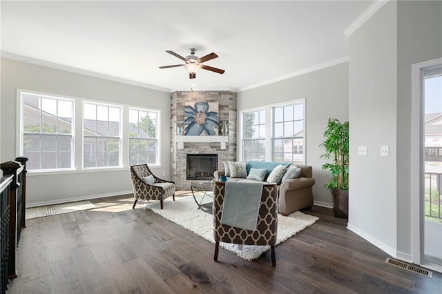11901 S Tallgrass Dr Unit 702, Olathe, KS 66061 - living room with crown molding, a ceiling fan, a stone fireplace, dark wood-style flooring, and baseboards