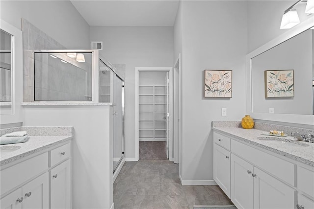 11901 S Tallgrass Dr Unit 702, Olathe, KS 66061 - bathroom with a shower stall, two vanities, and a walk in closet