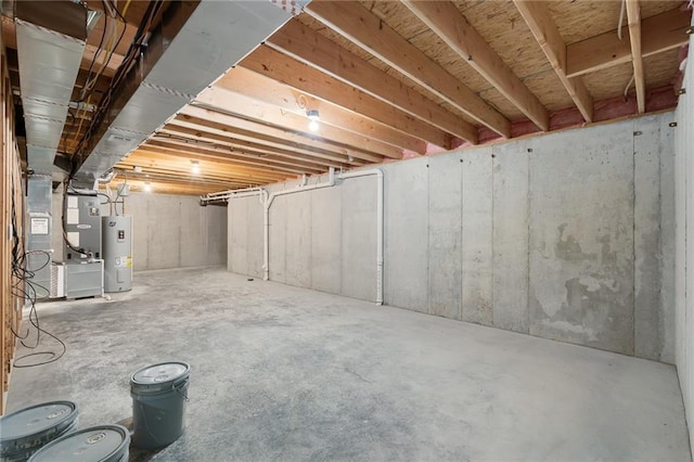 basement featuring water heater and heating unit