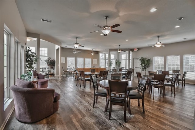 dining space with a healthy amount of sunlight and dark hardwood / wood-style flooring