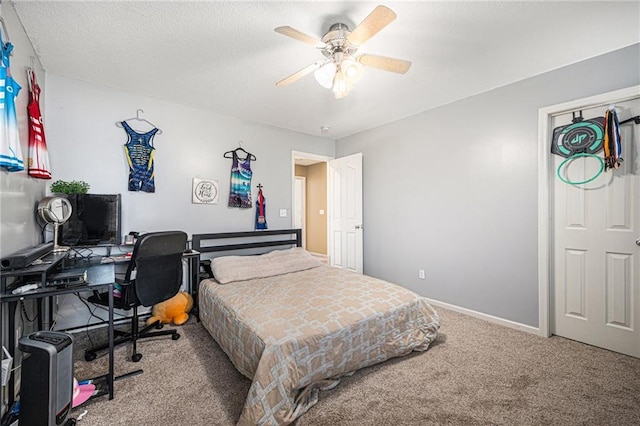 carpeted bedroom featuring a textured ceiling and ceiling fan