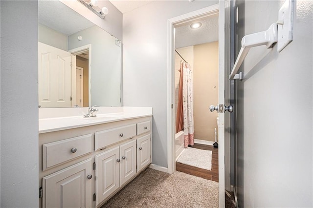 bathroom with shower / tub combo, vanity, and hardwood / wood-style flooring