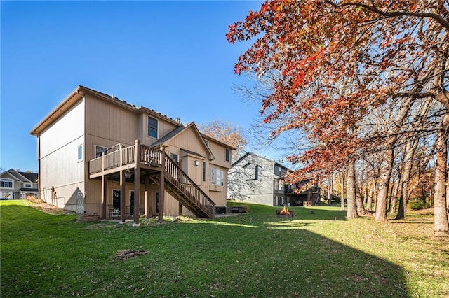 back of house with a lawn and a wooden deck