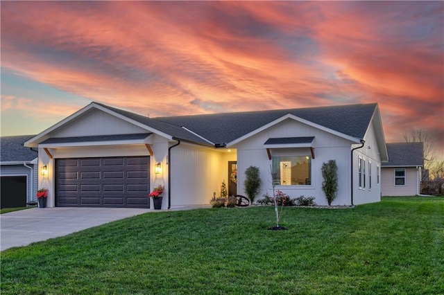 ranch-style house featuring a garage and a yard