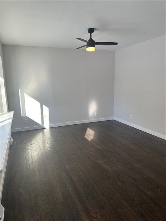 unfurnished room with ceiling fan and dark hardwood / wood-style flooring