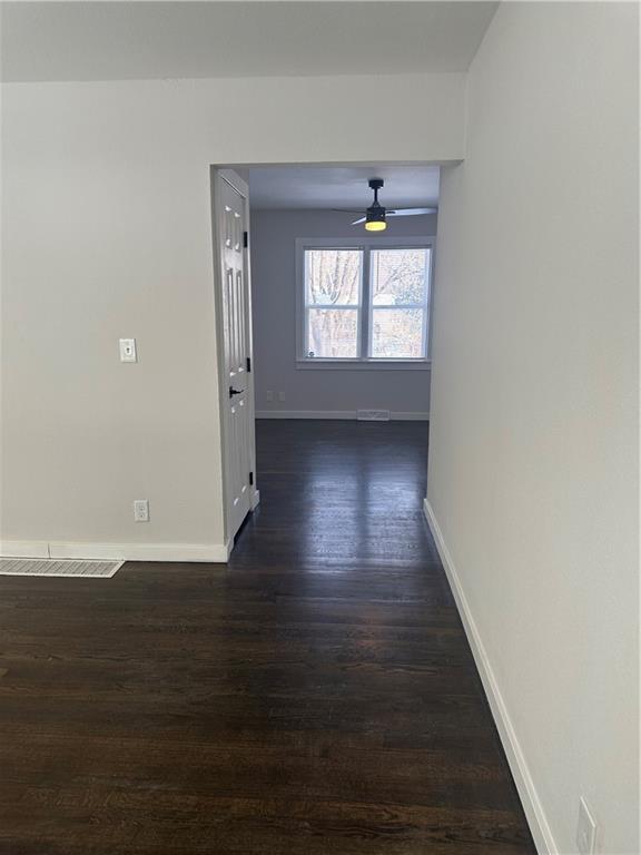 hallway featuring dark wood-type flooring